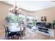 Bright dining area featuring a stylish chandelier, large windows, and views of the backyard pool at 16441 S Mountain Stone Trl, Phoenix, AZ 85048
