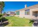 Well-maintained exterior with desert landscaping, lush lawn, and pristine pool at 16441 S Mountain Stone Trl, Phoenix, AZ 85048
