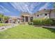 Stunning stucco home featuring a manicured lawn and a circular entryway with prominent columns at 16441 S Mountain Stone Trl, Phoenix, AZ 85048