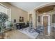 Elegant foyer featuring a grand entryway, arched doorways, and travertine flooring throughout at 16441 S Mountain Stone Trl, Phoenix, AZ 85048