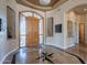 Elegant foyer with a custom wood door, and decorative marble floors with starburst accent at 16441 S Mountain Stone Trl, Phoenix, AZ 85048