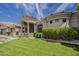 Inviting front exterior with manicured lawn, desert plants, and grand entrance at 16441 S Mountain Stone Trl, Phoenix, AZ 85048