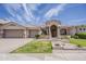 Stunning home exterior featuring a circular entry, tiled roof, three car garage, and well-manicured landscaping at 16441 S Mountain Stone Trl, Phoenix, AZ 85048