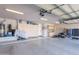 Spacious three car garage with ample storage cabinets, epoxy floor and organized storage system at 16441 S Mountain Stone Trl, Phoenix, AZ 85048