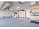 Clean three-car garage featuring ample storage cabinets, lots of open space and organized storage solutions at 16441 S Mountain Stone Trl, Phoenix, AZ 85048