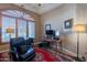 Warm and inviting home office showcasing custom built-in shelves and a window with views at 16441 S Mountain Stone Trl, Phoenix, AZ 85048