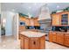 A gourmet kitchen featuring custom cabinets, a large island, and stainless steel appliances at 16441 S Mountain Stone Trl, Phoenix, AZ 85048