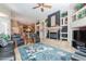Spacious living room with tile flooring, fireplace, and seamless access to the kitchen at 16441 S Mountain Stone Trl, Phoenix, AZ 85048