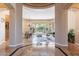 Open-concept living room and dining area featuring travertine floors and views of the backyard at 16441 S Mountain Stone Trl, Phoenix, AZ 85048