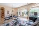 Open-concept living room and dining area featuring travertine floors and backyard views at 16441 S Mountain Stone Trl, Phoenix, AZ 85048