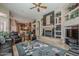 Inviting living room showcasing a cozy fireplace, custom built-ins, and an open floor plan at 16441 S Mountain Stone Trl, Phoenix, AZ 85048