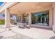 Expansive covered patio with ceiling fans and ample seating, ideal for entertaining guests at 16441 S Mountain Stone Trl, Phoenix, AZ 85048