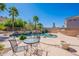 Beautiful pool and spa area with rock waterfall and lush landscaping for a tranquil retreat at 16441 S Mountain Stone Trl, Phoenix, AZ 85048