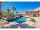 Beautiful backyard with a sparkling pool, built-in grill, and lush landscaping at 16441 S Mountain Stone Trl, Phoenix, AZ 85048