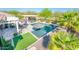 Aerial shot of a stunning pool with outdoor kitchen and lush, green turf at 17054 W Saguaro Park Ln, Surprise, AZ 85387