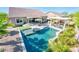 Aerial view of a backyard oasis with pool, outdoor kitchen, and lush landscaping at 17054 W Saguaro Park Ln, Surprise, AZ 85387