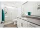 Sleek bathroom with a glass-enclosed shower and stylish vanity with gray countertop at 17054 W Saguaro Park Ln, Surprise, AZ 85387