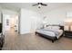Spacious bedroom with tile floors leading to a connected bathroom at 17054 W Saguaro Park Ln, Surprise, AZ 85387