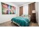 Eclectic bedroom featuring a colorful tapestry and matching decorative pillows at 17054 W Saguaro Park Ln, Surprise, AZ 85387