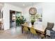 Dining area with wood table, modern chairs, and sliding door to patio at 17054 W Saguaro Park Ln, Surprise, AZ 85387