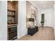 Elegant entryway with a wine fridge and beverage center, featuring stylish decor and a modern design at 17054 W Saguaro Park Ln, Surprise, AZ 85387