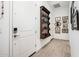 Bright entryway featuring tile flooring and wall decor with a dark wooden shelf display at 17054 W Saguaro Park Ln, Surprise, AZ 85387