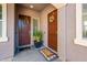 Two front doors with decorative wreaths, creating a warm welcome and an inviting entryway at 17054 W Saguaro Park Ln, Surprise, AZ 85387