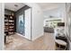 Open hallway leading to a living area, featuring tile floors, neutral walls, and ample natural light at 17054 W Saguaro Park Ln, Surprise, AZ 85387