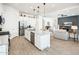 Open-concept kitchen and living space featuring stainless appliances and ample counter space at 17054 W Saguaro Park Ln, Surprise, AZ 85387