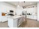 Elegant kitchen featuring an island with barstools, stainless appliances, and sleek countertops at 17054 W Saguaro Park Ln, Surprise, AZ 85387