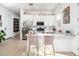 Modern kitchen with a center island, stainless steel appliances, and chic chandeliers at 17054 W Saguaro Park Ln, Surprise, AZ 85387