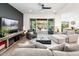 Comfortable living room with a modern ceiling fan, cozy seating, and seamless indoor-outdoor living at 17054 W Saguaro Park Ln, Surprise, AZ 85387
