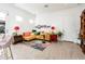 Cozy living room features tiled flooring, comfortable seating with a bright yellow couch and homey decor at 17054 W Saguaro Park Ln, Surprise, AZ 85387