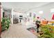 Open concept living space featuring tiled floors, white kitchen, and a cozy seating area at 17054 W Saguaro Park Ln, Surprise, AZ 85387