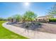 Beautiful park pathway with shaded seating areas, enhancing the community's appeal and providing residents a relaxing space at 17054 W Saguaro Park Ln, Surprise, AZ 85387
