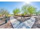 Scenic walking path, framed by lush trees and landscaping, providing a tranquil outdoor space for exercise and relaxation at 17054 W Saguaro Park Ln, Surprise, AZ 85387
