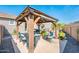 Inviting backyard patio area featuring a pergola, with comfortable seating, perfect for outdoor relaxation and entertaining at 17054 W Saguaro Park Ln, Surprise, AZ 85387