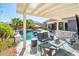 Outdoor living space with a swimming pool, poolside seating, and a covered patio with bar seating at 17054 W Saguaro Park Ln, Surprise, AZ 85387