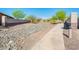 Well-maintained street with desert landscaping and walking paths, offering a serene and inviting neighborhood environment at 17054 W Saguaro Park Ln, Surprise, AZ 85387