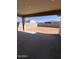 Back patio is covered and shaded, features a concrete base, and an open yard in the distance at 18225 W Larkspur Dr, Goodyear, AZ 85338