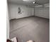 Clean, empty garage with a grey floor, white walls, and a metal garage door. Ready to park your car! at 18225 W Larkspur Dr, Goodyear, AZ 85338