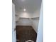 Empty walk-in closet with shelving, dark carpet, and white walls is ready for its owner at 18225 W Larkspur Dr, Goodyear, AZ 85338