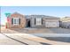 Charming single-story home showcasing stone accents, gray shutters, tile roof, and a paved driveway at 18840 N 269Th Ave, Buckeye, AZ 85396