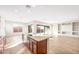 Open-concept kitchen with island, stainless steel sink, granite countertops and views to living area at 18840 N 269Th Ave, Buckeye, AZ 85396