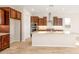 Modern kitchen featuring wooden cabinets, granite counters, stainless steel appliances, and a center island at 18840 N 269Th Ave, Buckeye, AZ 85396