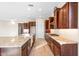Bright kitchen features granite counters, tile floors, stainless steel appliances, and dark wood cabinetry at 18840 N 269Th Ave, Buckeye, AZ 85396