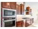 Gourmet kitchen features stainless steel microwave, oven and range top at 18840 N 269Th Ave, Buckeye, AZ 85396