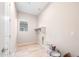 Spacious laundry room with tile floors, storage shelf and utility connections at 18840 N 269Th Ave, Buckeye, AZ 85396