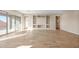 Expansive living area with tile flooring, sliding doors, and a stylish built-in entertainment unit at 18840 N 269Th Ave, Buckeye, AZ 85396
