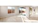 Bright and airy living area features tile flooring and large sliding glass doors to outdoor living space at 18840 N 269Th Ave, Buckeye, AZ 85396